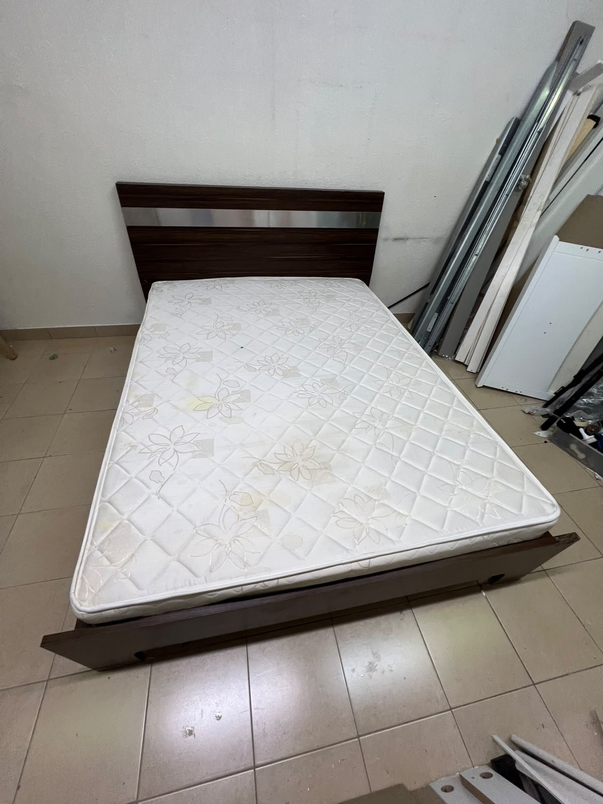 A dark brown wooden double bed featuring a headboard accented with a silver metal strip, and equipped with a white padded mattress. - Image 9