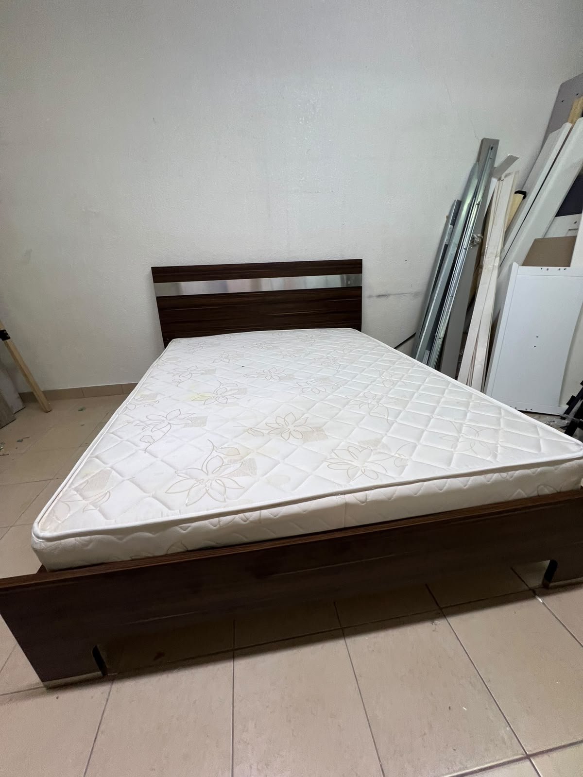 A dark brown wooden double bed featuring a headboard accented with a silver metal strip, and equipped with a white padded mattress. - Image 10