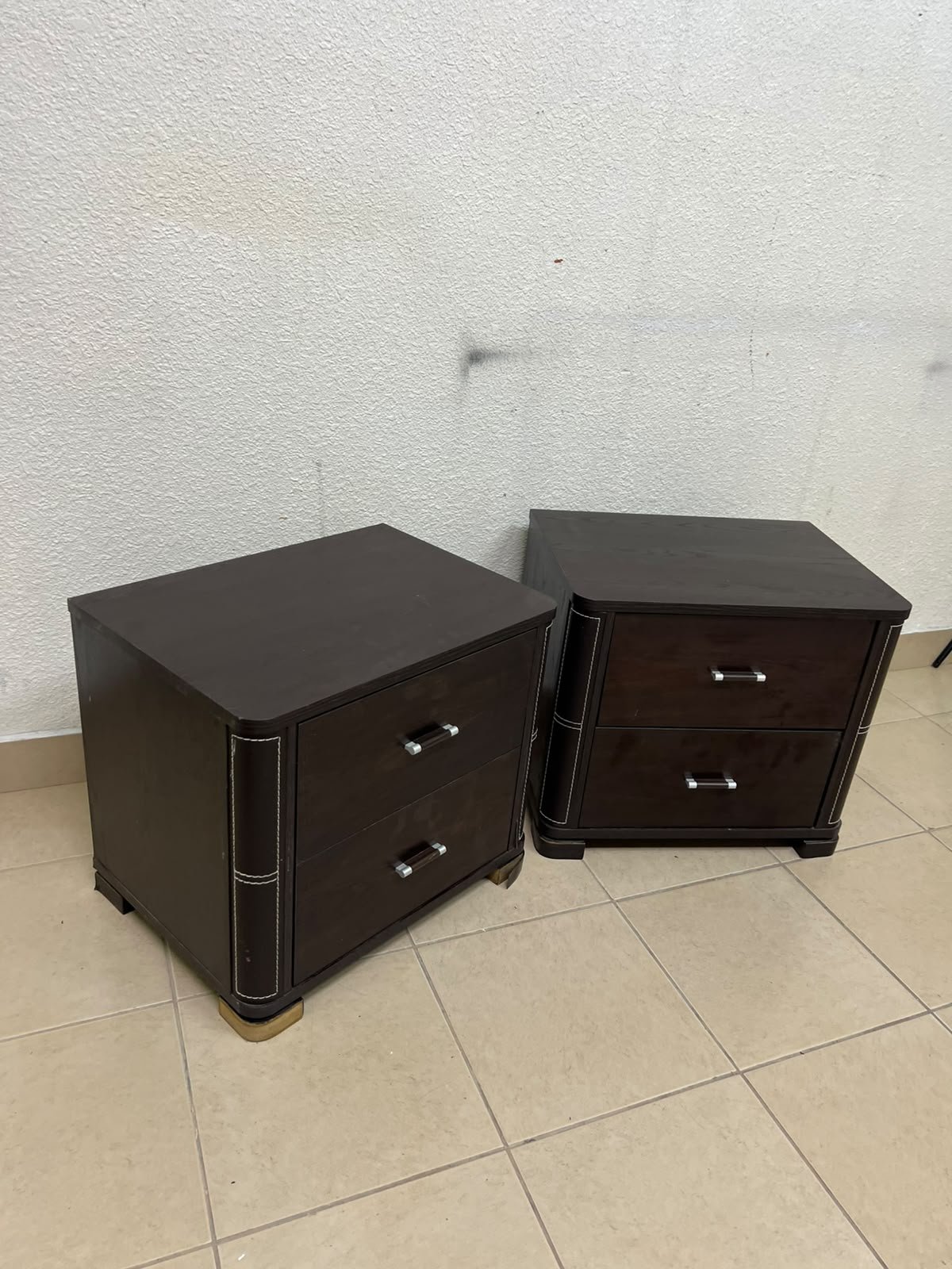 Two dark brown wooden bedside tables (nightstands) featuring two drawers and curved corners, accented with contrasting white stitching and silver-colored metal drawer handles. - Image 8