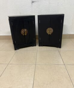 Two bedside cabinets featuring an Asian design or Oriental-inspired style, crafted from wood with a black finish and fitted with traditional round brass handles.