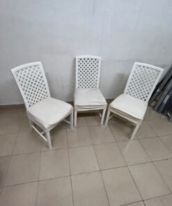 A set of white wooden chairs featuring a woven-mesh backrest design and white seat covers. - Image 2