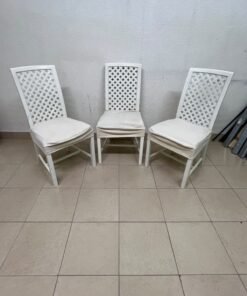 A set of white wooden chairs featuring a woven-mesh backrest design and white seat covers.