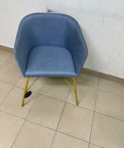 A modern barrel-style armchair or upholstered dining chair, featuring light blue fabric upholstery and slender yellow metal legs. - Image 7