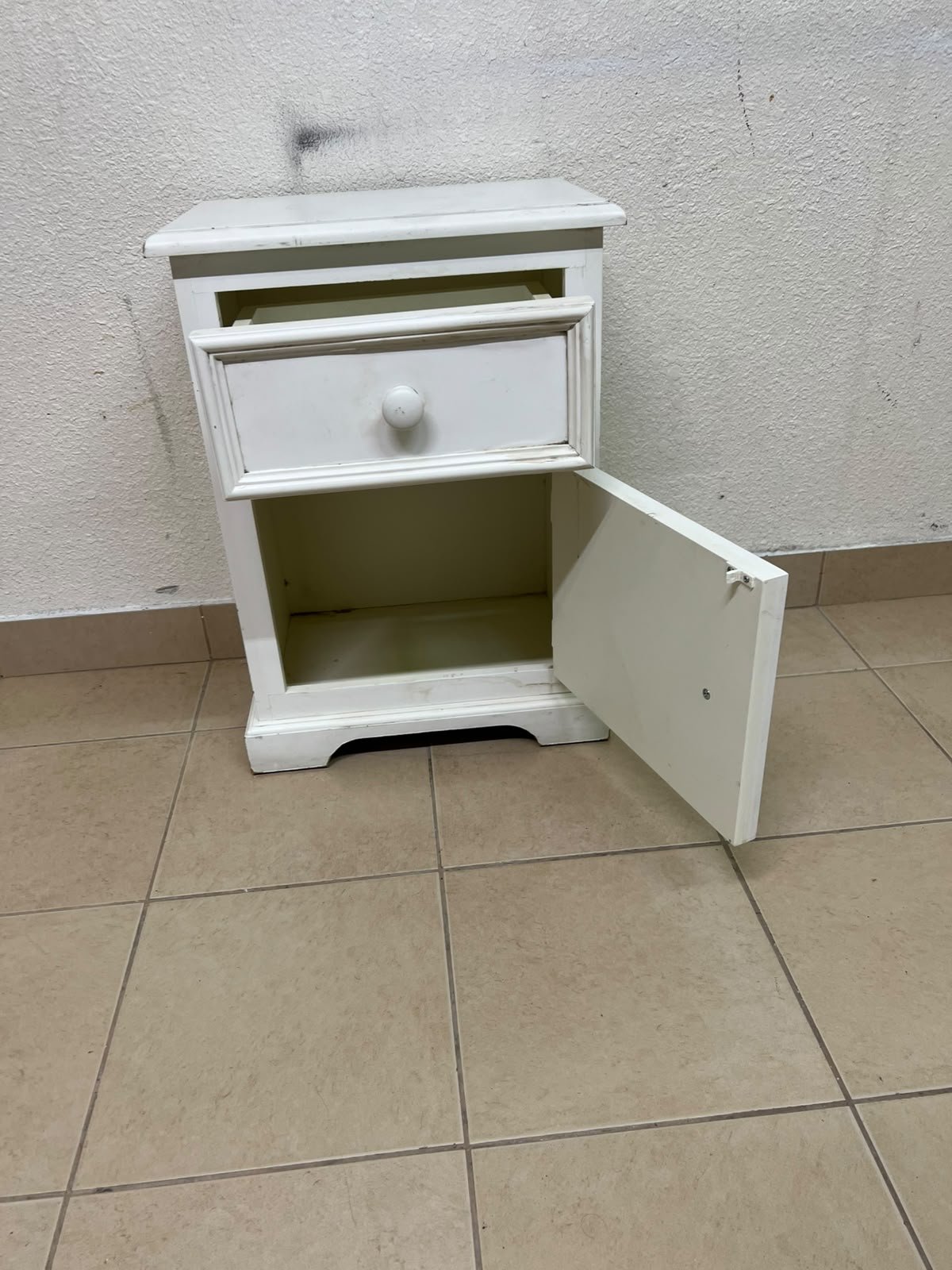 A white side table or nightstand featuring a traditional, classic design, comprising an upper drawer and a lower cabinet with a door, both fitted with round wooden knobs. - Image 2