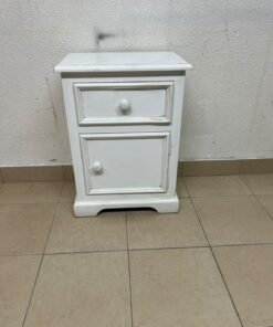 A white side table or nightstand featuring a traditional, classic design, comprising an upper drawer and a lower cabinet with a door, both fitted with round wooden knobs. - Image 3