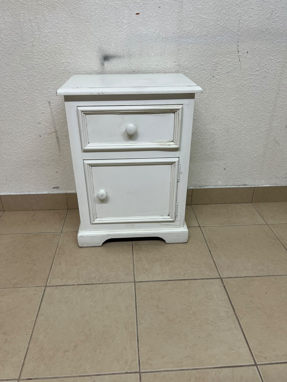 A white side table or nightstand featuring a traditional, classic design, comprising an upper drawer and a lower cabinet with a door, both fitted with round wooden knobs. - Image 3