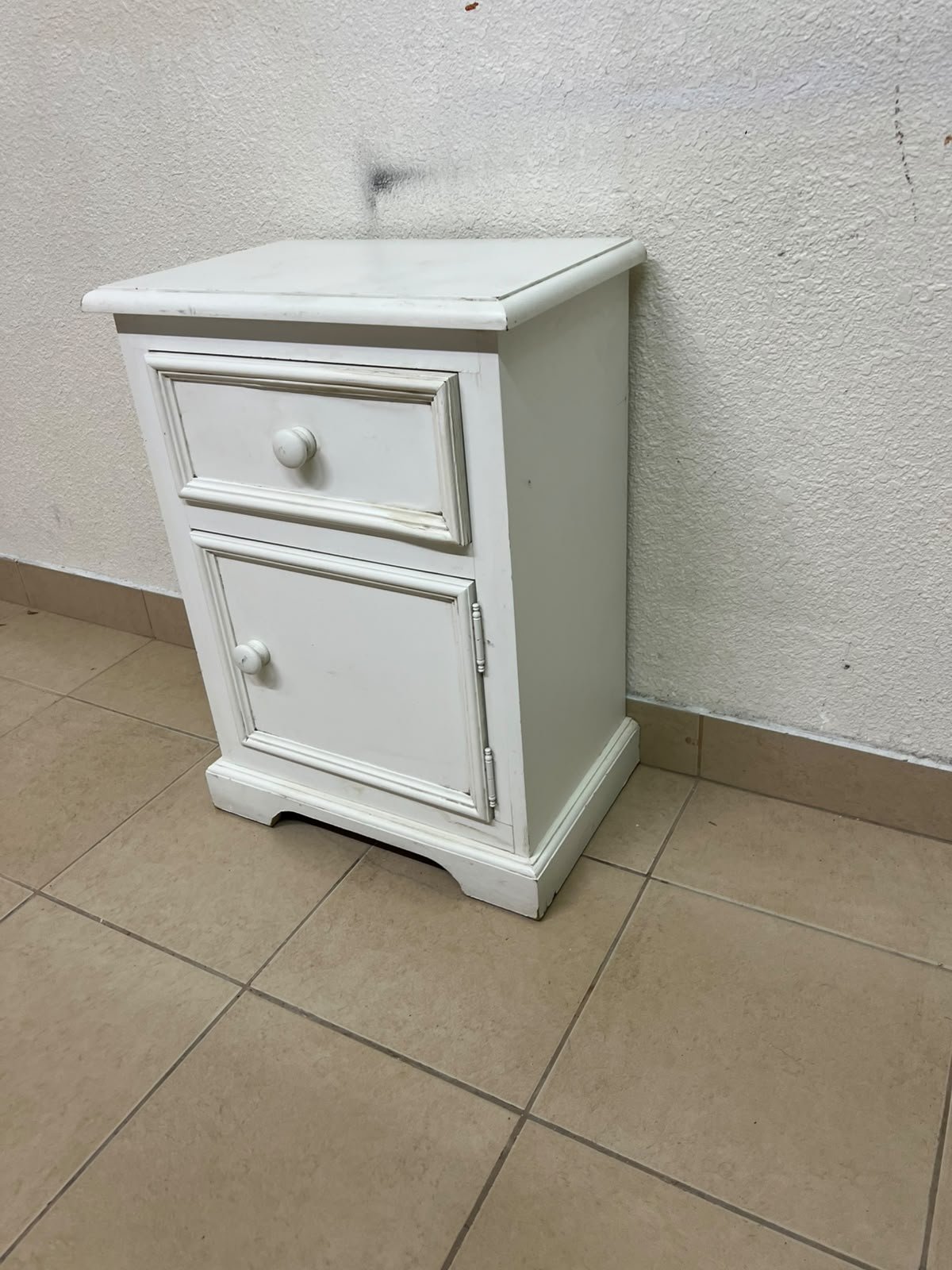 A white side table or nightstand featuring a traditional, classic design, comprising an upper drawer and a lower cabinet with a door, both fitted with round wooden knobs. - Image 8