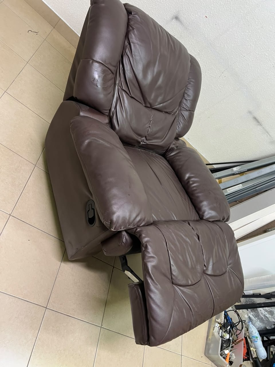 A brown faux leather single recliner featuring padded armrests and backrest, and a manual side handle for position control. - Image 9