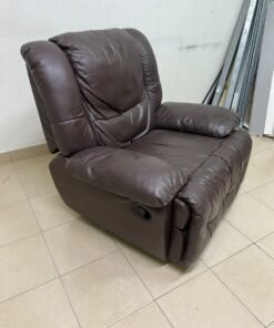 A brown faux leather single recliner featuring padded armrests and backrest, and a manual side handle for position control.
