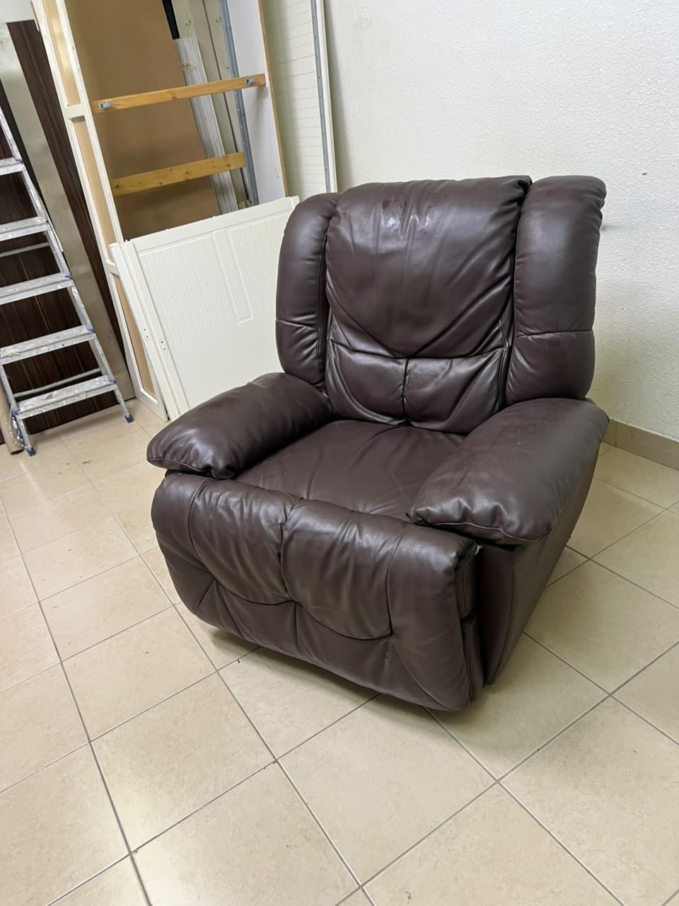 A brown faux leather single recliner featuring padded armrests and backrest, and a manual side handle for position control. - Image 12