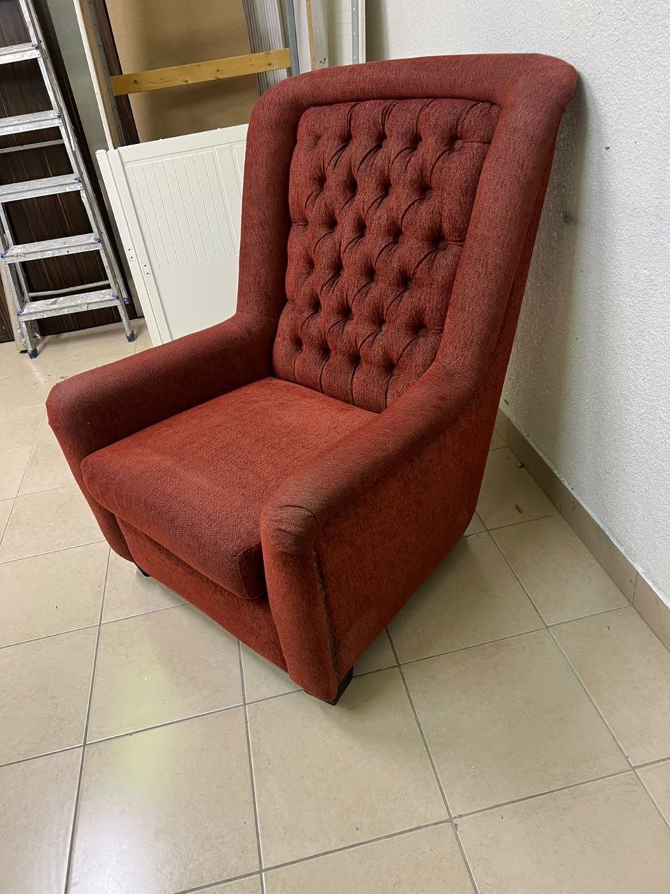 A classic-style armchair featuring a high, button-tufted backrest, upholstered in textured dark red fabric, and accented with metal nailhead trim along the edges. - Image 5
