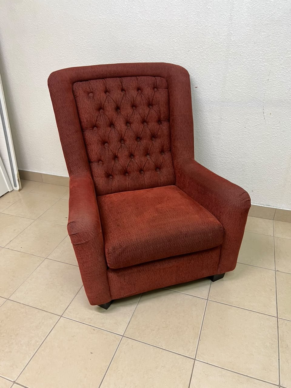 A classic-style armchair featuring a high, button-tufted backrest, upholstered in textured dark red fabric, and accented with metal nailhead trim along the edges. - Image 8