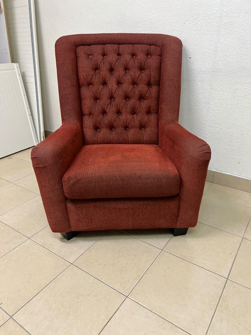 A classic-style armchair featuring a high, button-tufted backrest, upholstered in textured dark red fabric, and accented with metal nailhead trim along the edges. - Image 2