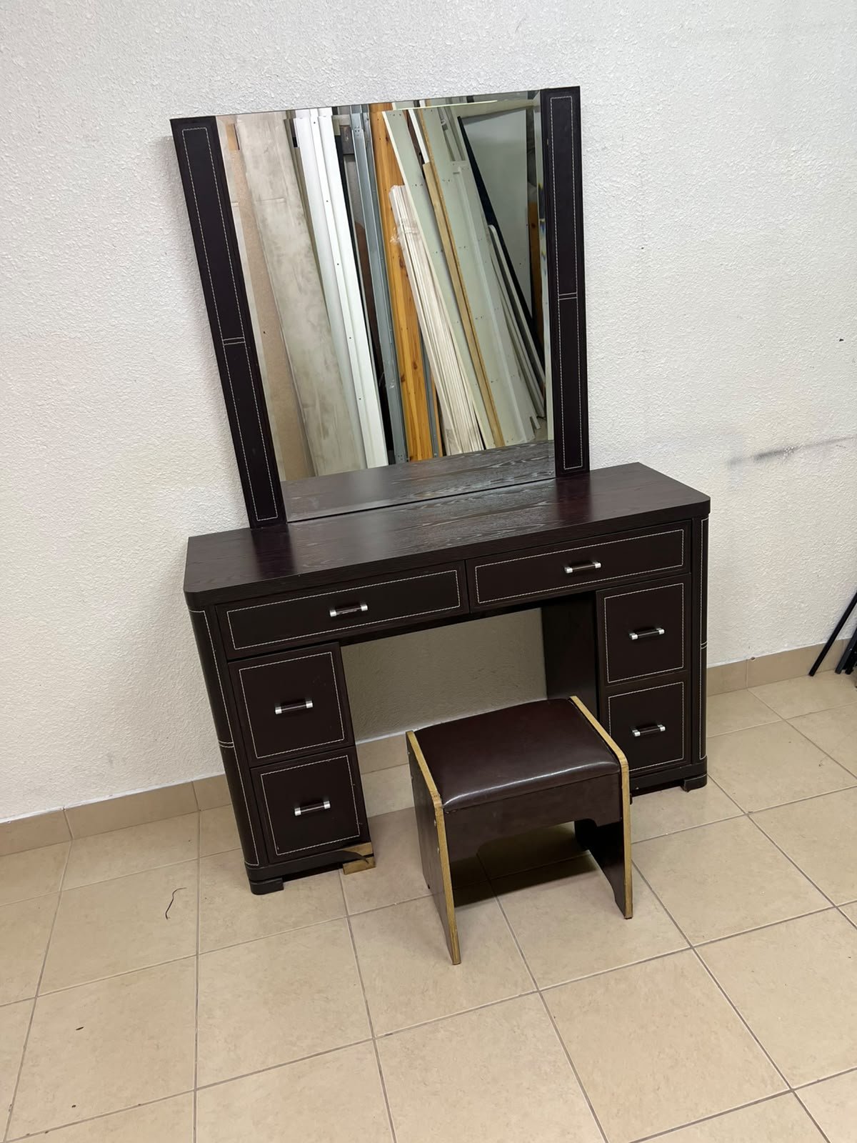 The image shows a brown wooden vanity table with an attached mirror and multiple drawers. - Image 2