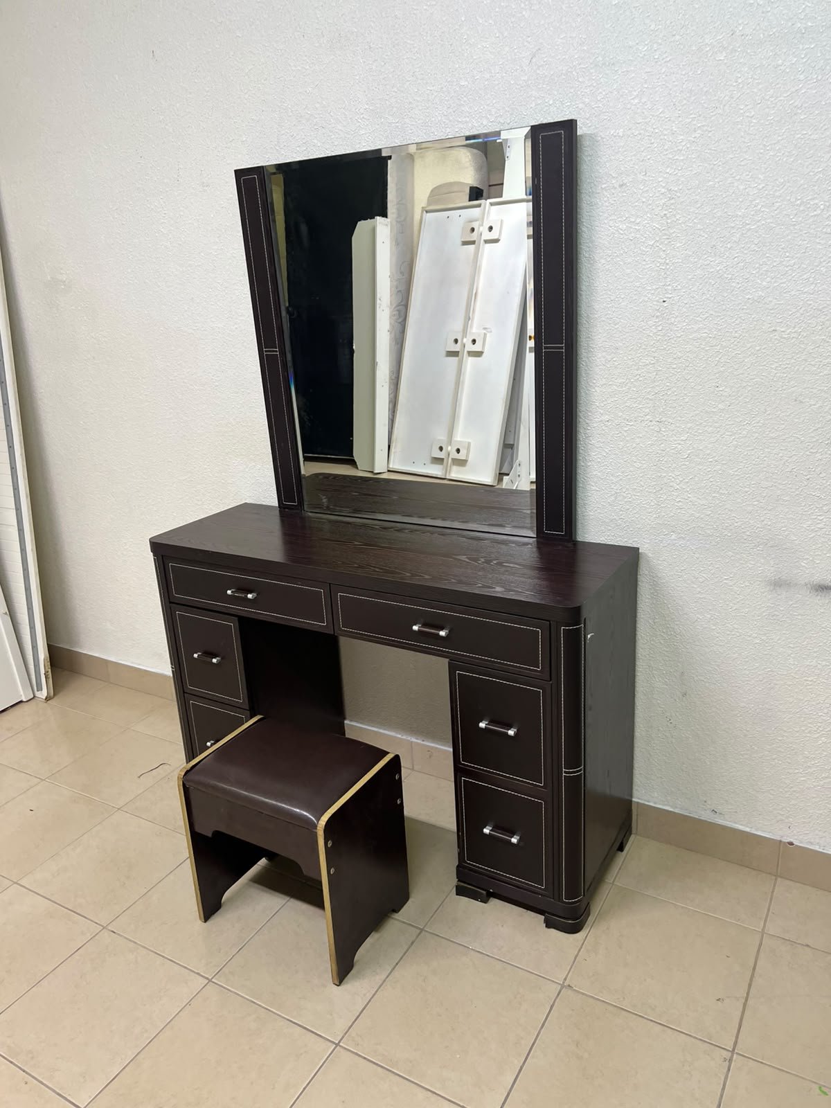 The image shows a brown wooden vanity table with an attached mirror and multiple drawers. - Image 8
