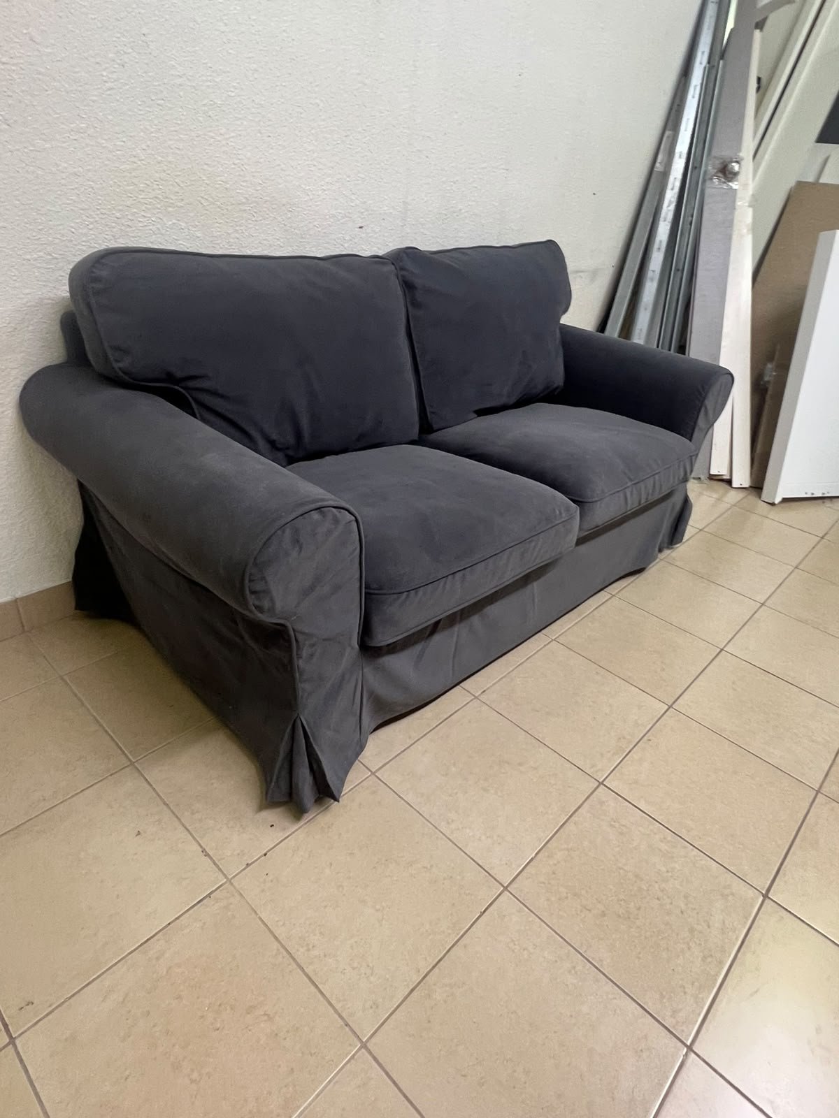 The IKEA EKTORP 2-seat sofa features a dark gray slipcover, a classic design, and comfortable, removable, and washable seat cushions. - Image 2