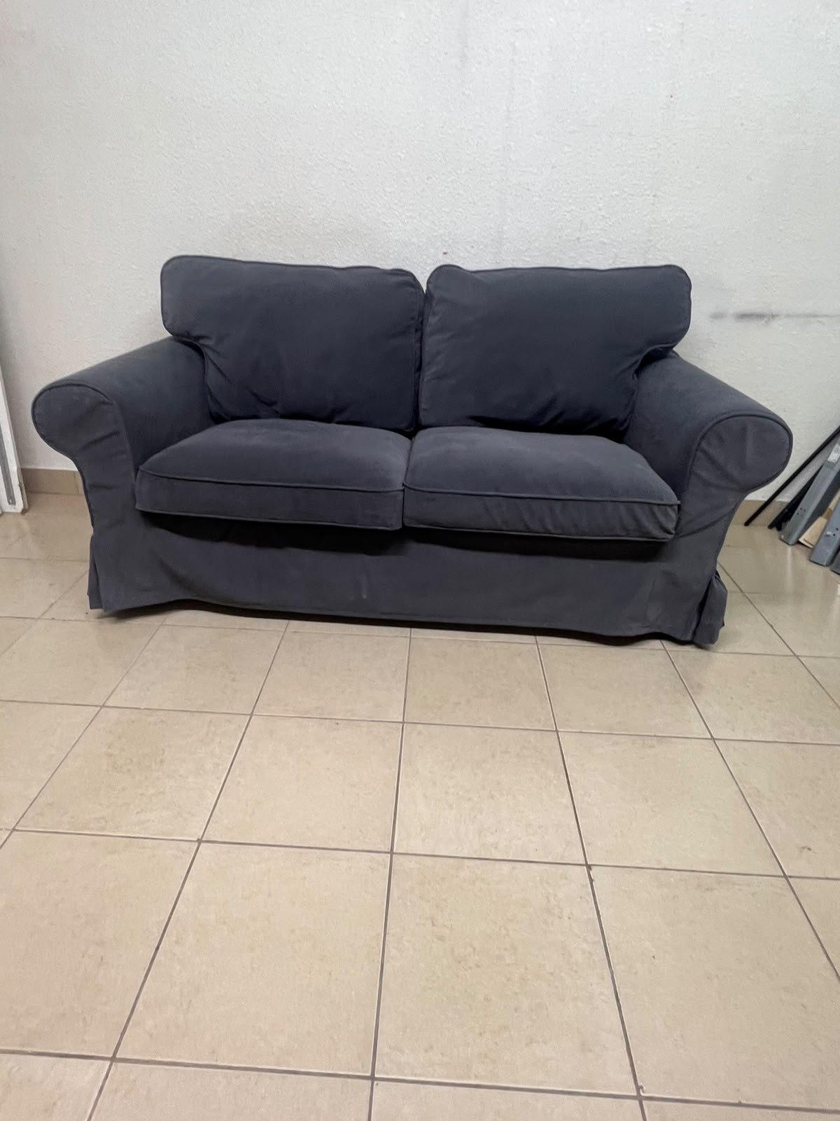The IKEA EKTORP 2-seat sofa features a dark gray slipcover, a classic design, and comfortable, removable, and washable seat cushions.