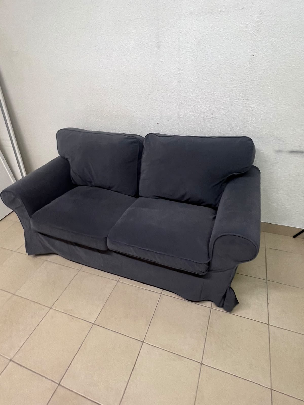 The IKEA EKTORP 2-seat sofa features a dark gray slipcover, a classic design, and comfortable, removable, and washable seat cushions. - Image 7