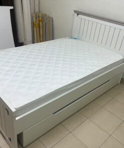 A white wooden single bed featuring a pull-out trundle bed underneath, with two matching padded mattresses. - Image 4