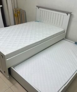 A white wooden single bed featuring a pull-out trundle bed underneath, with two matching padded mattresses. - Image 5