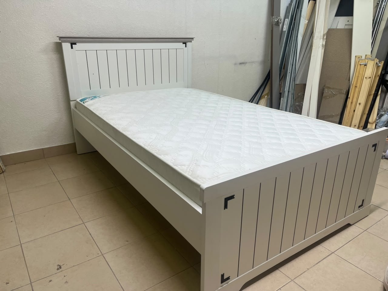 A white wooden single bed featuring a pull-out trundle bed underneath, with two matching padded mattresses. - Image 6