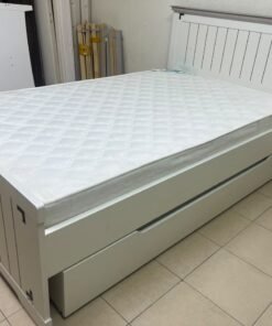 A white wooden single bed featuring a pull-out trundle bed underneath, with two matching padded mattresses. - Image 7
