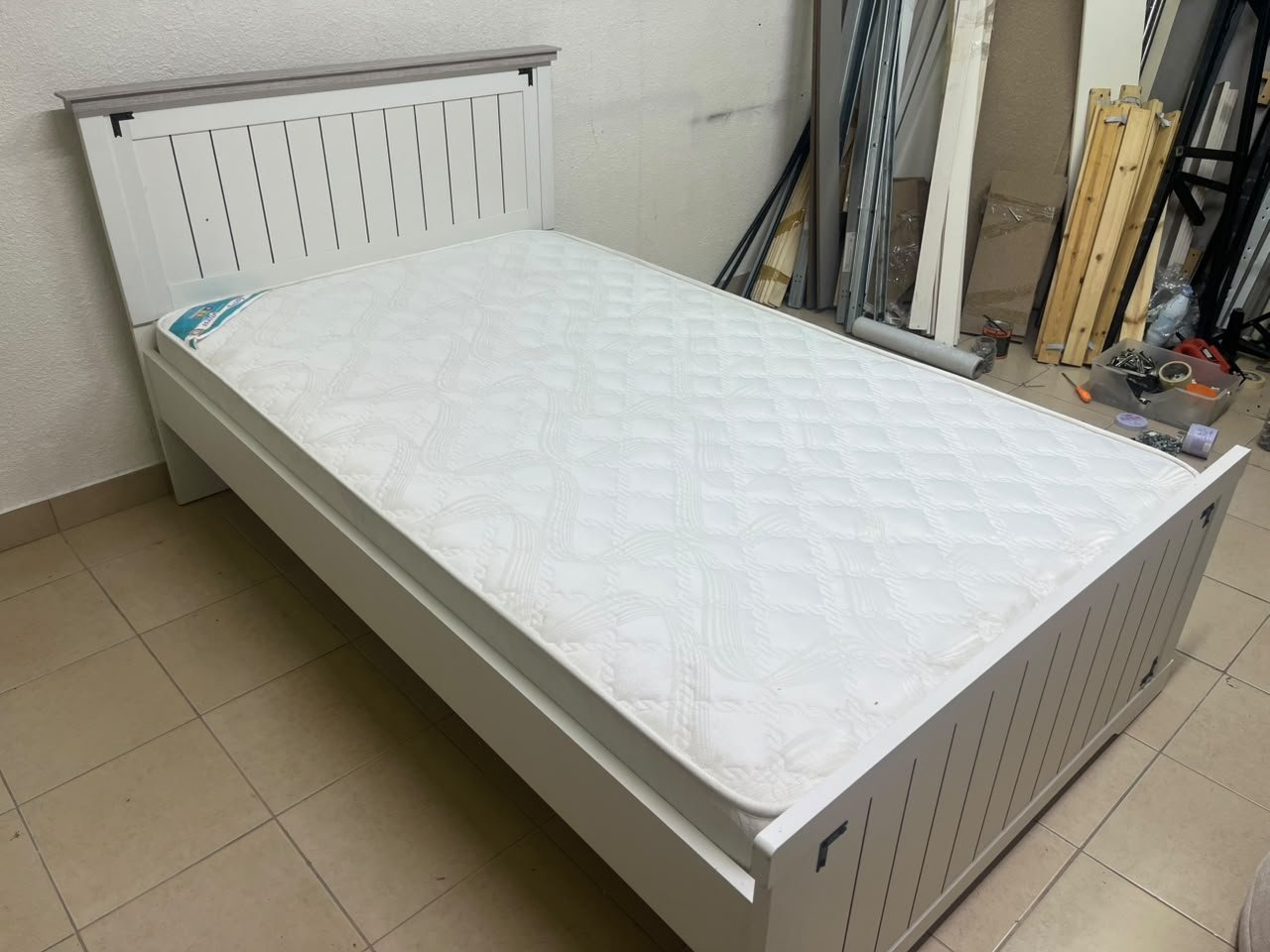 A white wooden single bed featuring a pull-out trundle bed underneath, with two matching padded mattresses. - Image 9