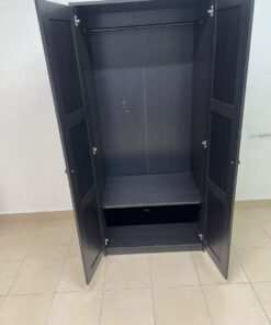 The RAKKESTAD two-door wardrobe from IKEA features a practical, simple design and measures approximately 79x176 cm; it comes in a black-brown finish. - Image 5