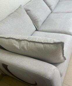 A modern sectional sofa upholstered in light gray fabric, featuring wide armrests with striking rounded details and matching, separate back cushions. - Image 5