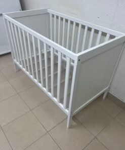 The white IKEA SUNDVIK crib (60x120 cm) features a sturdy wooden design and a bed base that can be adjusted to two different heights. - Image 7