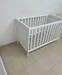 The white IKEA SUNDVIK crib (60x120 cm) features a sturdy wooden design and a bed base that can be adjusted to two different heights. - Image 8