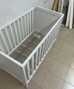 The white IKEA SUNDVIK crib (60x120 cm) features a sturdy wooden design and a bed base that can be adjusted to two different heights. - Image 9