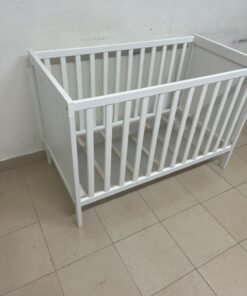 The white IKEA SUNDVIK crib (60x120 cm) features a sturdy wooden design and a bed base that can be adjusted to two different heights.