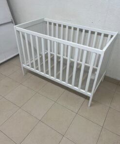The white IKEA SUNDVIK crib (60x120 cm) features a sturdy wooden design and a bed base that can be adjusted to two different heights. - Image 13