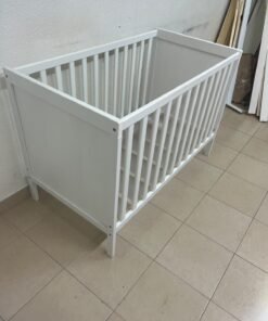 The white IKEA SUNDVIK crib (60x120 cm) features a sturdy wooden design and a bed base that can be adjusted to two different heights. - Image 14