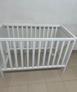 The white IKEA SUNDVIK crib (60x120 cm) features a sturdy wooden design and a bed base that can be adjusted to two different heights. - Image 2