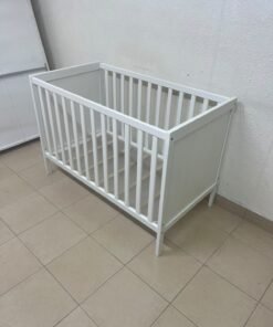 The white IKEA SUNDVIK crib (60x120 cm) features a sturdy wooden design and a bed base that can be adjusted to two different heights. - Image 3