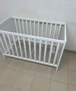 The white IKEA SUNDVIK crib (60x120 cm) features a sturdy wooden design and a bed base that can be adjusted to two different heights. - Image 4