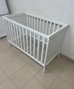 The white IKEA SUNDVIK crib (60x120 cm) features a sturdy wooden design and a bed base that can be adjusted to two different heights. - Image 5