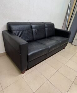 A modern three-seater black leather sofa featuring square armrests and wooden legs, resembling the IKEA "Skogaby" model. - Image 2