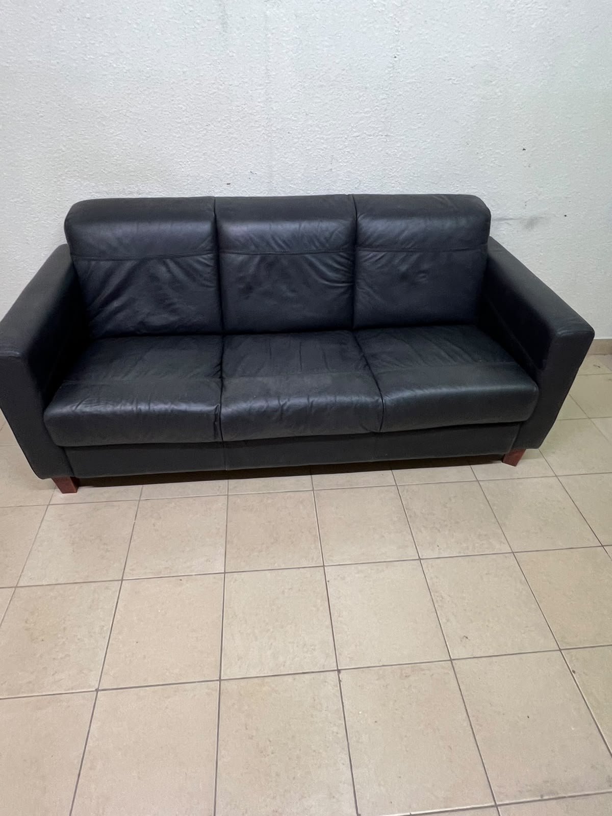 A modern three-seater black leather sofa featuring square armrests and wooden legs, resembling the IKEA "Skogaby" model. - Image 5