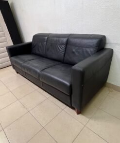 A modern three-seater black leather sofa featuring square armrests and wooden legs, resembling the IKEA "Skogaby" model. - Image 8