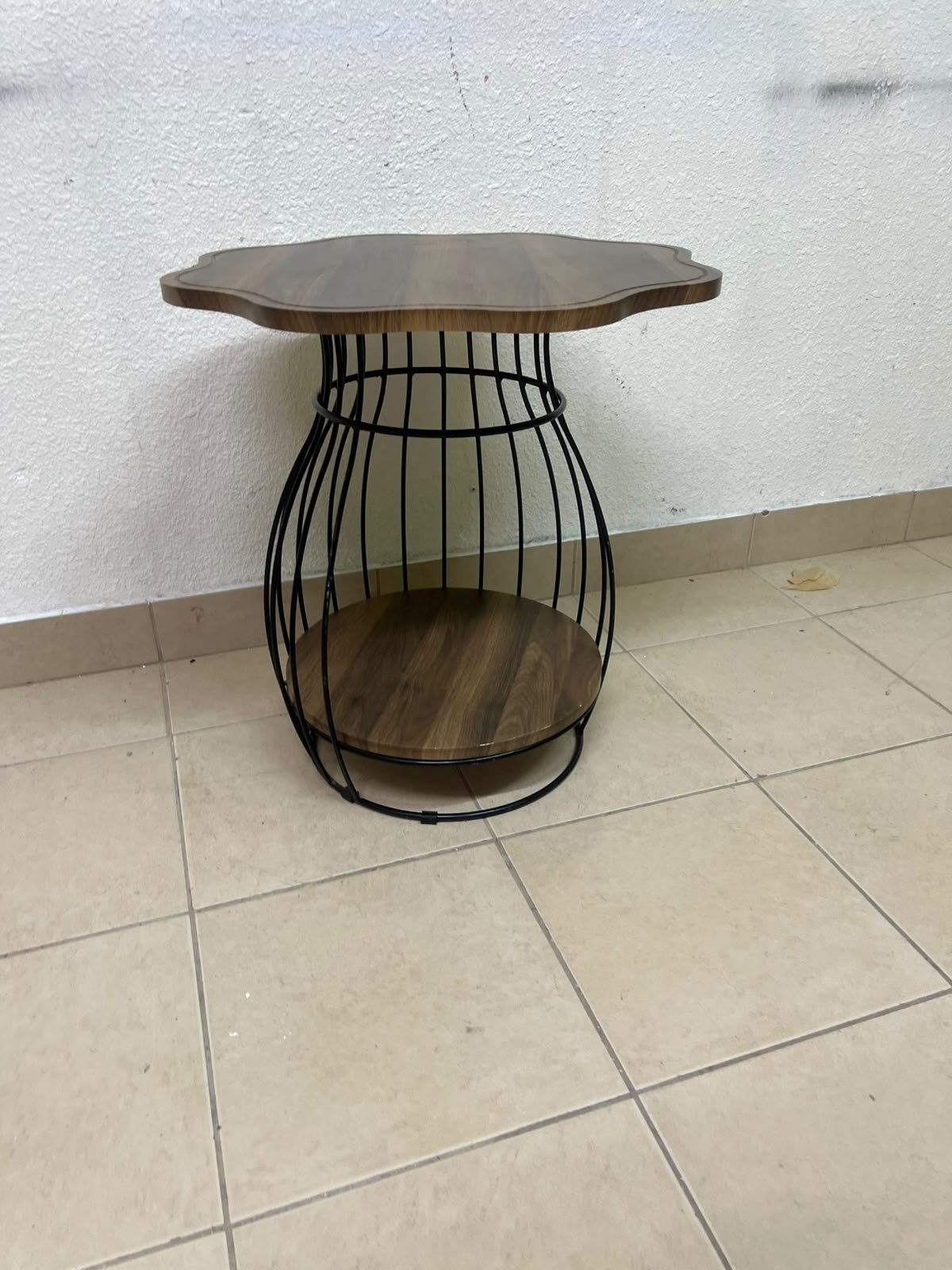 This modern two-tier side table features a wooden top with curved edges and a lower storage shelf enclosed by a black metal frame designed like a wire mesh cage. - Image 2
