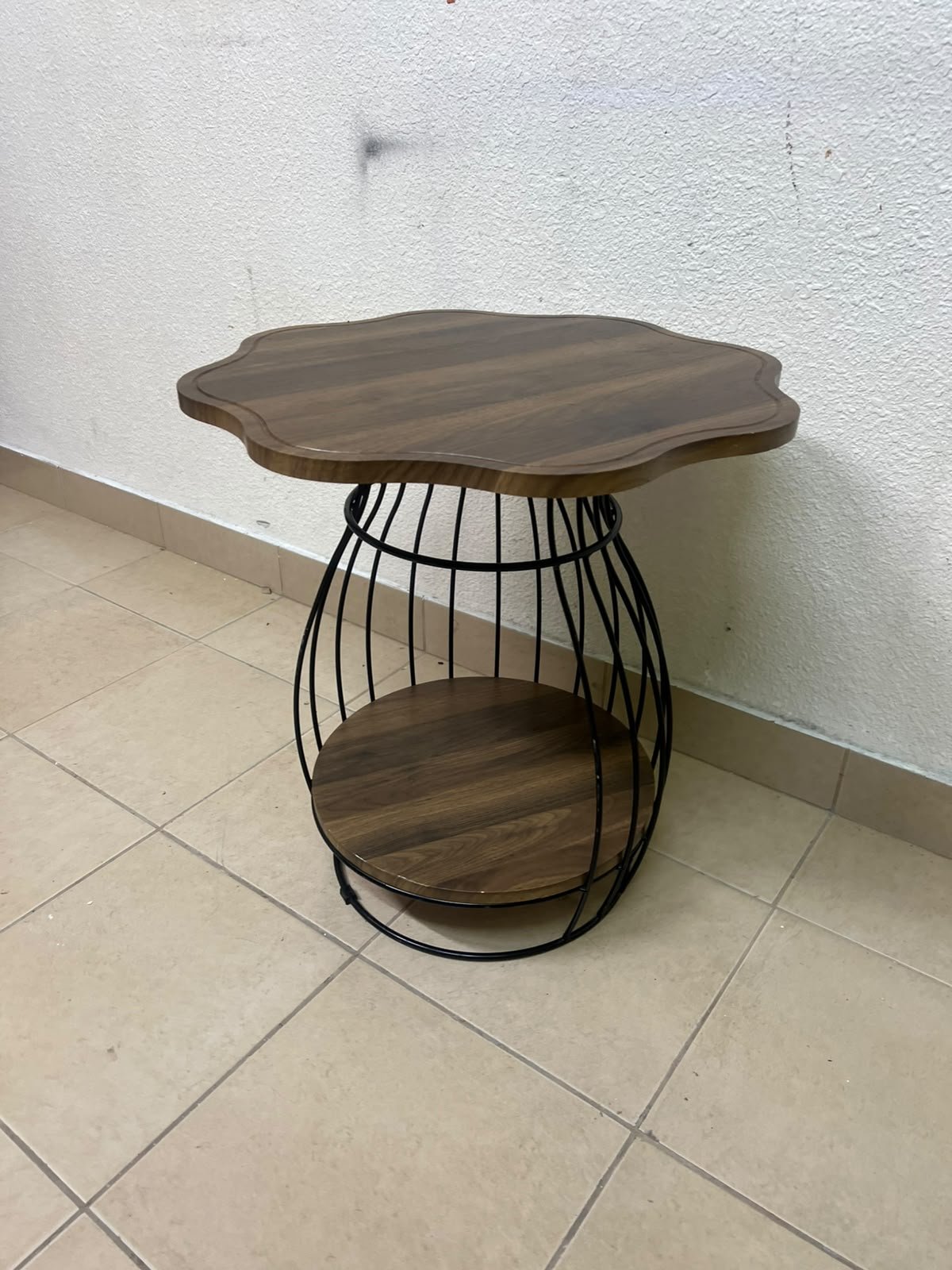 This modern two-tier side table features a wooden top with curved edges and a lower storage shelf enclosed by a black metal frame designed like a wire mesh cage. - Image 3