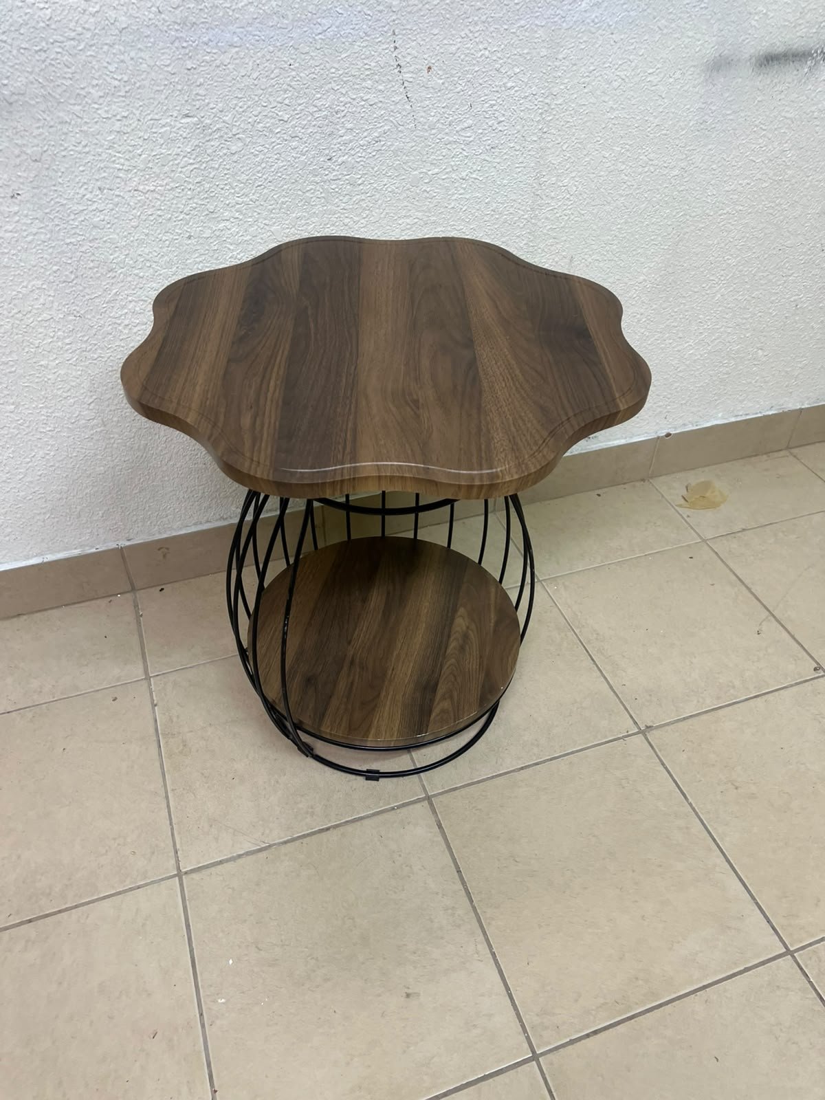 This modern two-tier side table features a wooden top with curved edges and a lower storage shelf enclosed by a black metal frame designed like a wire mesh cage. - Image 4