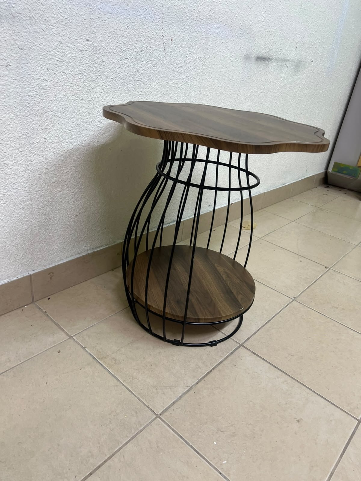 This modern two-tier side table features a wooden top with curved edges and a lower storage shelf enclosed by a black metal frame designed like a wire mesh cage. - Image 7