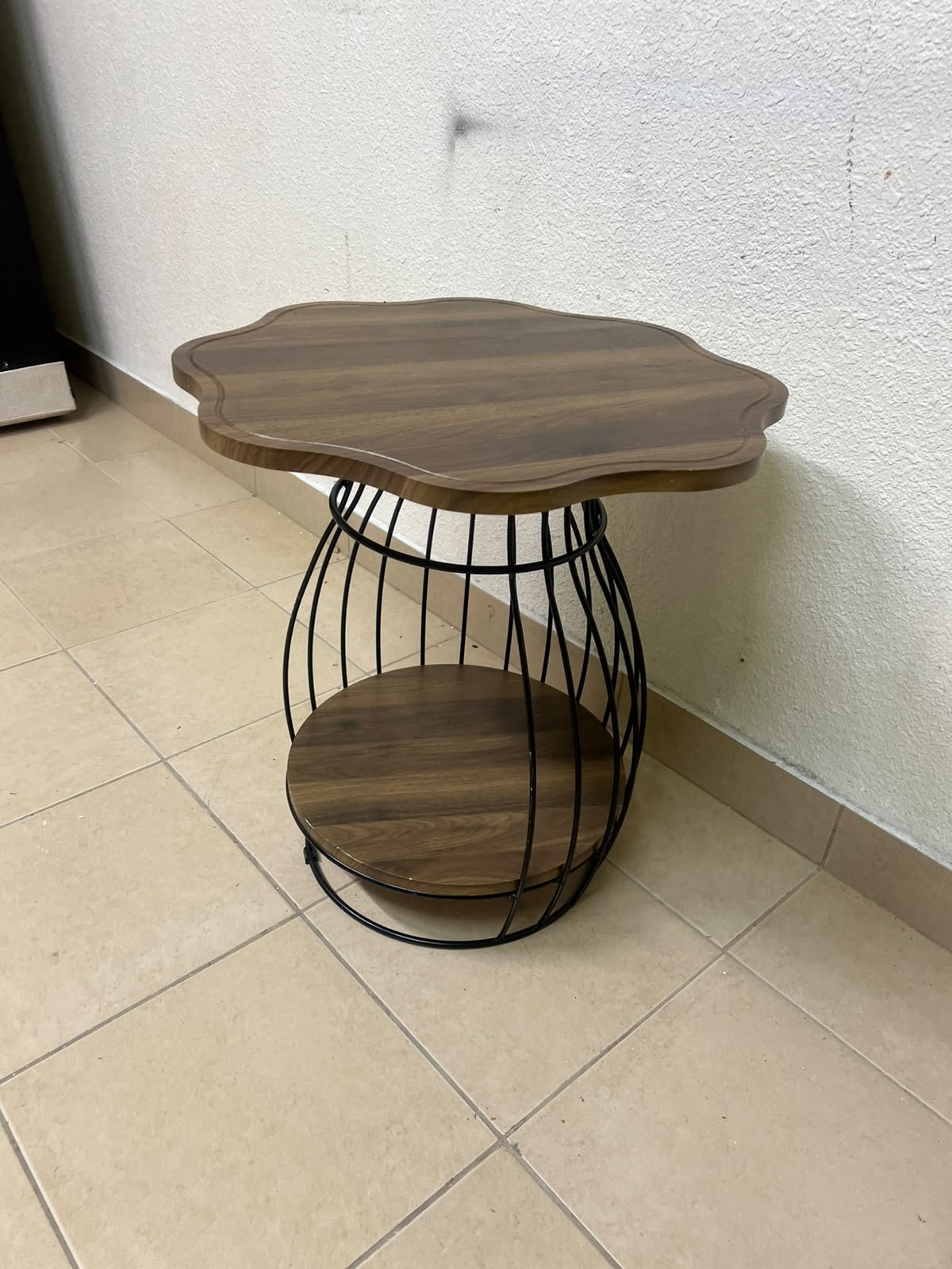 This modern two-tier side table features a wooden top with curved edges and a lower storage shelf enclosed by a black metal frame designed like a wire mesh cage. - Image 8