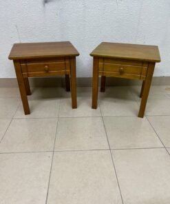 Two classic, medium-toned wooden side tables featuring a single drawer with a round wooden knob and classic grooved detailing on the frame. - Image 2