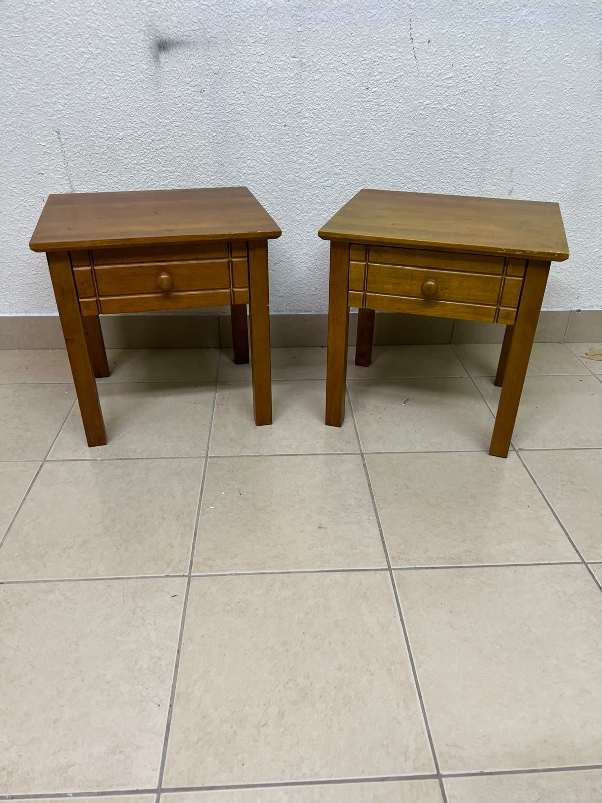 Two classic, medium-toned wooden side tables featuring a single drawer with a round wooden knob and classic grooved detailing on the frame. - Image 2