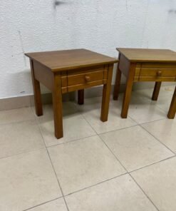 Two classic, medium-toned wooden side tables featuring a single drawer with a round wooden knob and classic grooved detailing on the frame. - Image 3